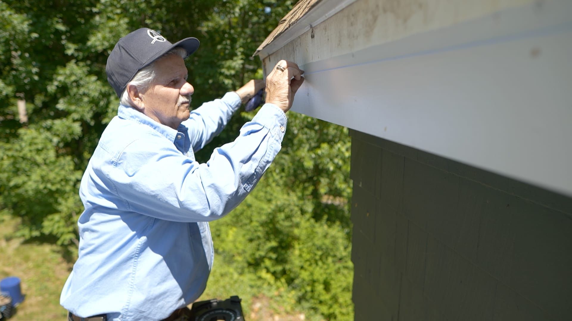 Tom Silva repairing a gutter.